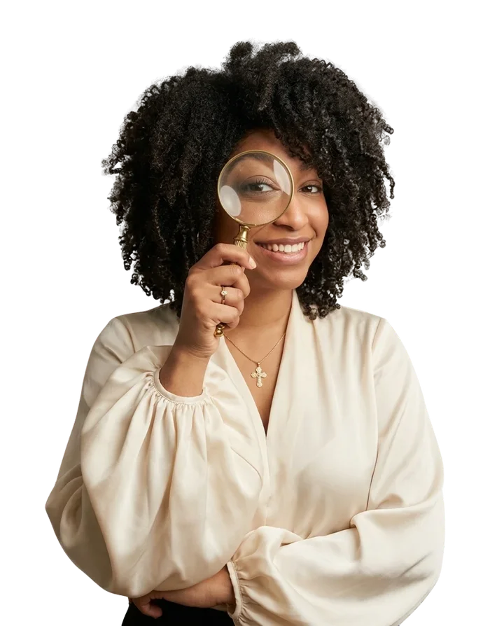 Sarah Parker, looking through a magnifying glass